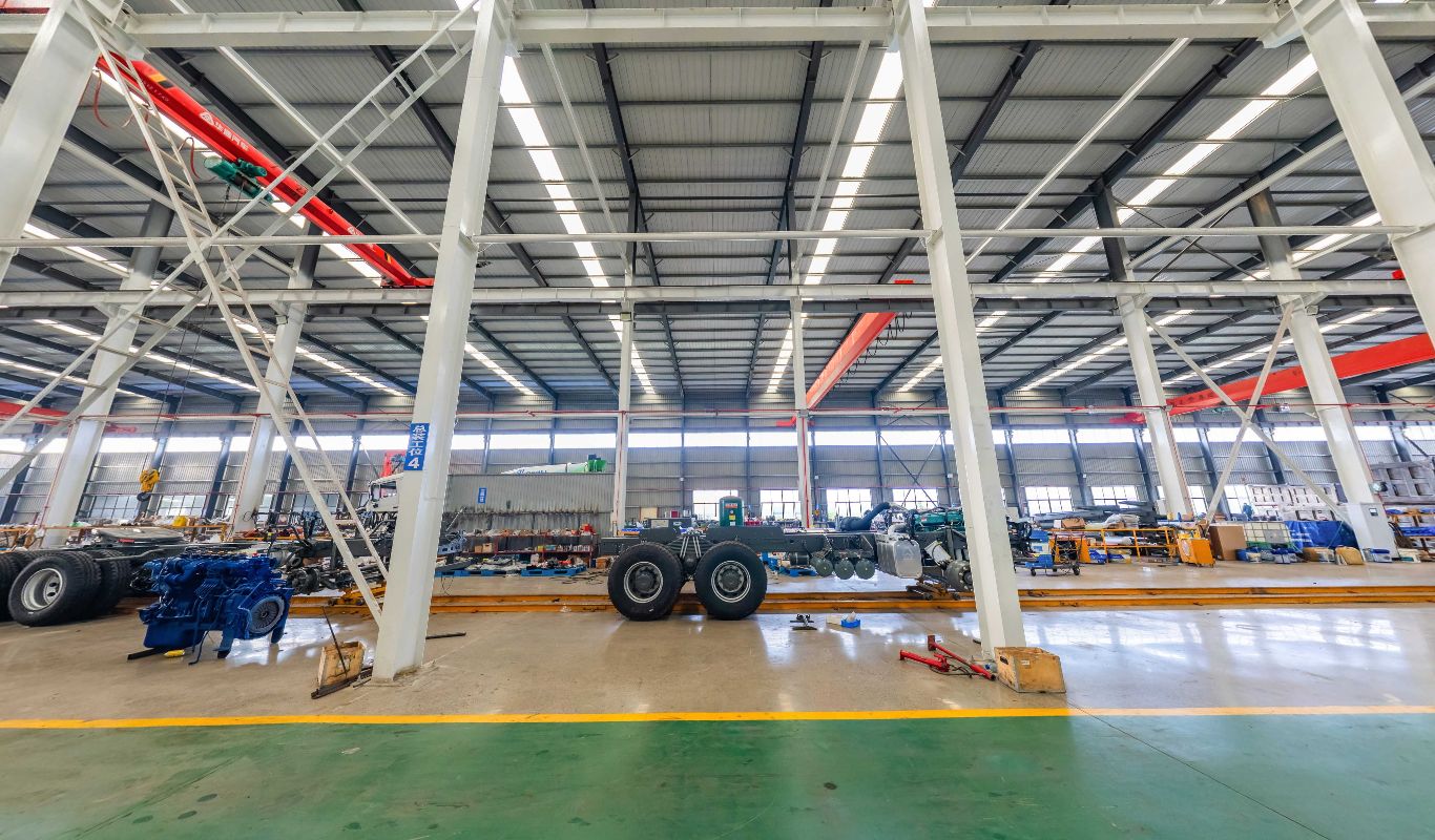 Truck assembly bay with a chassis, engines and overhead cranes
